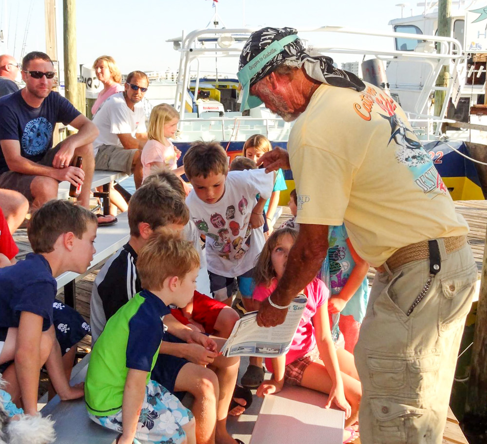 Bruce Cheves telling stories to the kids on the fishing docks