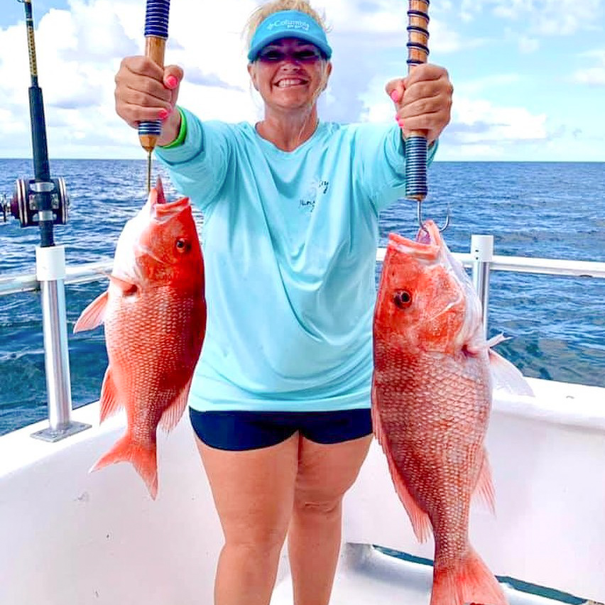 A lady with red snapper caught in Destin Florida