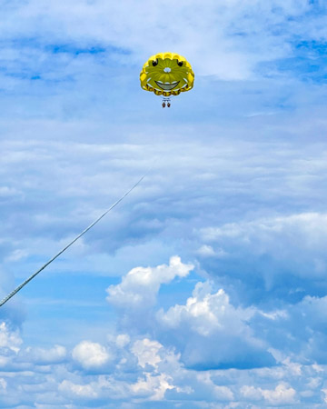 Parasailing parachute in the clouds in Destin Florida