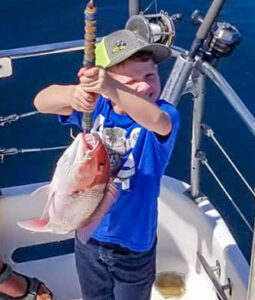 a child holding a fish caught in Destin Florida